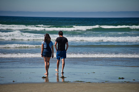 Mature couple walking on beautiful beach in Tofino, Canada