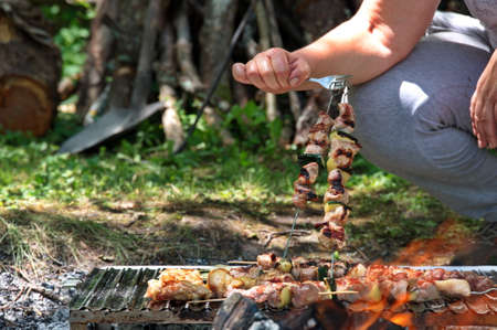 Grilling various meat and vegetables on flameの写真素材