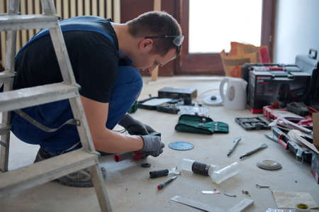 Handyman preparing tools for home improvementの写真素材
