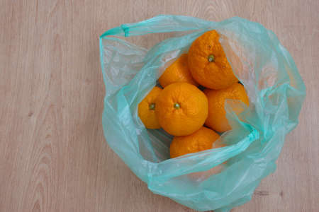 Directly above shot of tangerines in plastic bagの写真素材
