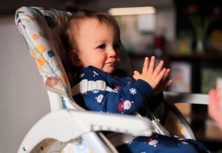 Cute little boy sitting in his chairの写真素材