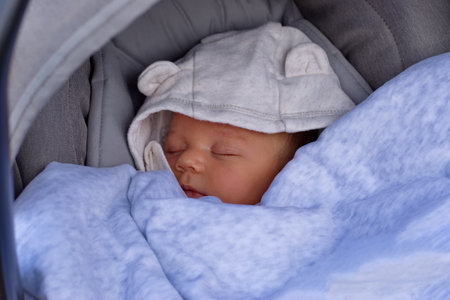Portrait of newborn baby in baby stroller