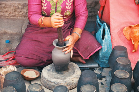 Midsection of professional potter making bowl in pottery workshop - Kathmandu, Nepalの写真素材
