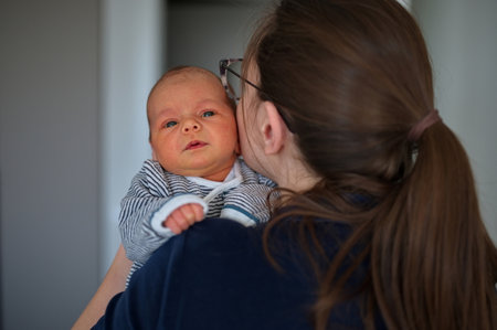Portrait of mother holding newborn baby