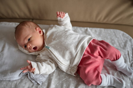 Portrait of cute newborn baby lying on blanketの写真素材