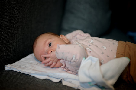 Portrait of cute newborn baby lying on blanketの写真素材