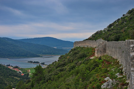 Medieval city walls in Ston, Croatia with salt pans in backgroundの写真素材