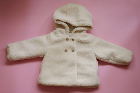 White baby coat against pink backgroundの写真素材