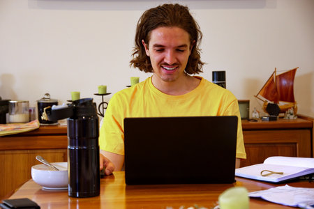 Young man working on laptop from homeの写真素材