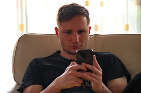 Closeup of handsome man using mobile phone