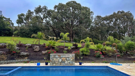 Swimming pool and garden in a rainy dayの写真素材