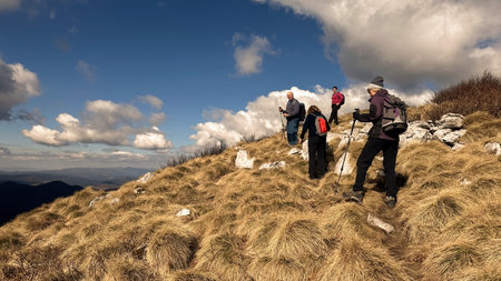 Small group of senior hikers on the mountain ridgeの写真素材