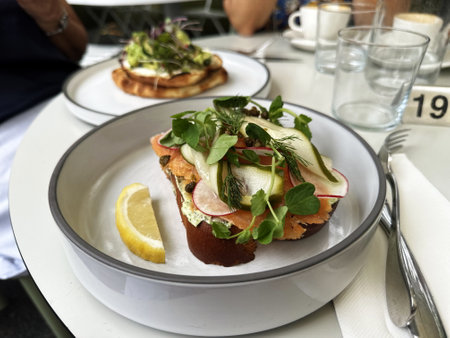 Closeup of sandwich with salmon and vegetables on the tableの写真素材