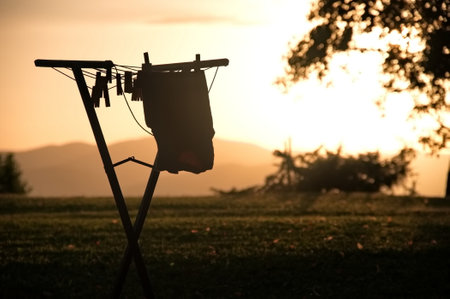 T-shirt is dried on a drying rack at sunsetの写真素材