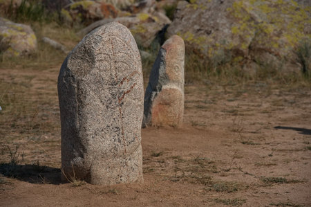 Ancient gravestones in open-air petroglyph museum in Kyrgyzstanの写真素材