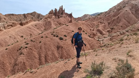 Senior woman hiking in Skazka canyon in Kyrgyzstanの写真素材