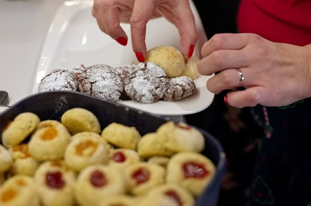 Closeup of hands putting cookies on the plateの写真素材