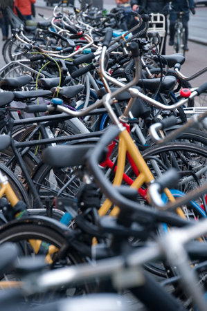Bicycle parking area on sidewalk with a lot of colorful bicycles