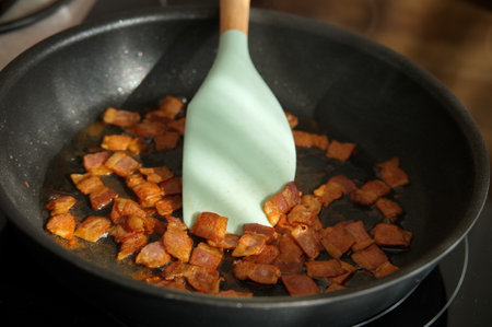 High angle view of frying bacon in frying panの写真素材