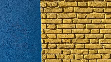 Bright colorful brick wall in yellow and blue