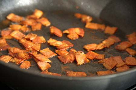 High angle view of frying bacon in frying panの写真素材