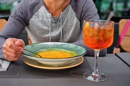 Midsection of man eating a pumpkin soupの写真素材