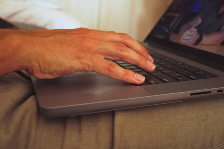 Closeup of man hand using laptop