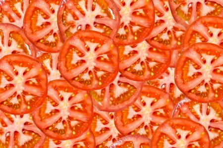 ripe tomatoes. tomato slices. Background from tomatoesの写真素材