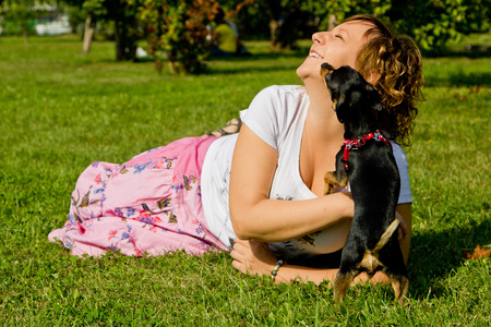 girl playing with dogの写真素材