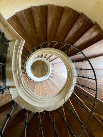 A spiral staircase with wooden steps in the Church of the Assumption of the Virgin Mary and St. John...