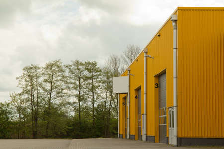 yellow building with a cloudy backgroundの写真素材