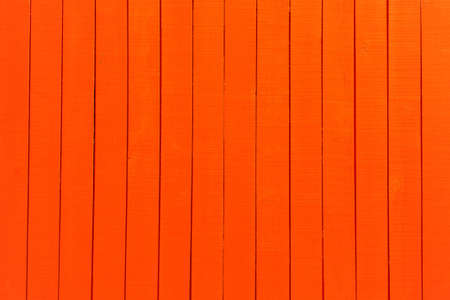 an orange fence with vertical planks backgroundの写真素材