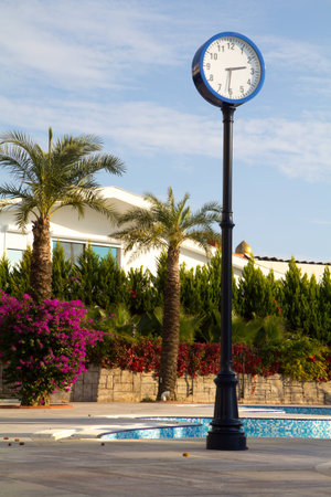 a post with a clock on it with the sky as backgroundの写真素材
