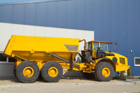 a big dump truck is on a raised gravel tray