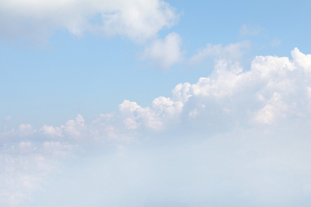 Clear blue sky background with white clouds.の写真素材