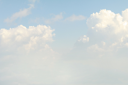 Clear blue sky background with white clouds.の写真素材