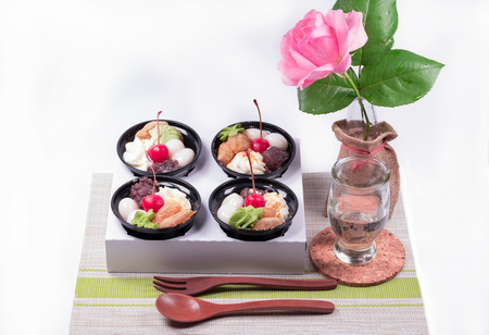 Dessert with red berries and green tea cream with flowers and  white background.の写真素材