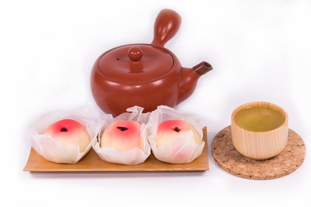 Japanese Traditional Sweets (Wagashi) ,made of mochi, anko, and fruits,Wagashi are typically made from plant ingredients, Hot green tea so delicious and teapot on white backgroundの写真素材