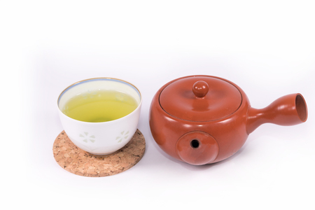 Hot green tea so delicious and teapot on white background.の写真素材