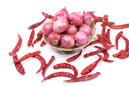 Dried chilies and  shallots  on white background.の写真素材
