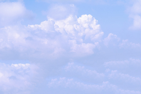 Clear blue sky background with white clouds.の写真素材