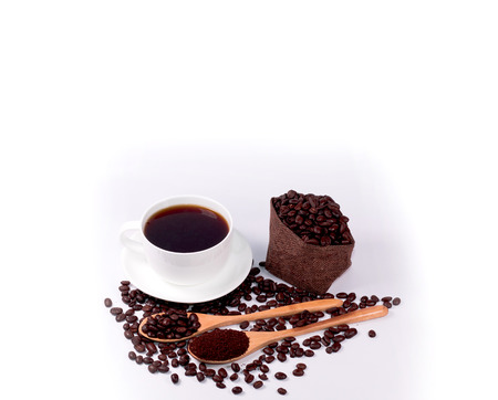 Coffee beans  and black coffee in white cup with Coffee beans in wooden spoon on  white background.の写真素材