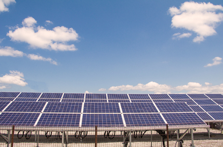 Solar  power panels for innovation green energy for life with mountains and blue sky background.の写真素材