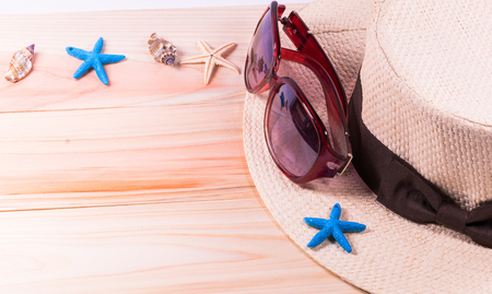 Summer beach vacation,straw hat,sunglasses ,Sea objects  on wooden background with copy space.の写真素材