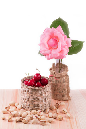 Cherries with pistachio , flower and white background with clipping path.の写真素材