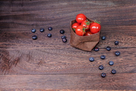 Healthy eating and dieting concept,fresh  tomato ,fruit,vegetables on a grey wooden table wall background with copy space .の写真素材