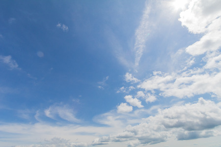 Clear blue sky background with white clouds.の写真素材