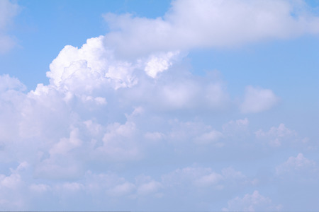 Clear blue sky background with white clouds.の写真素材