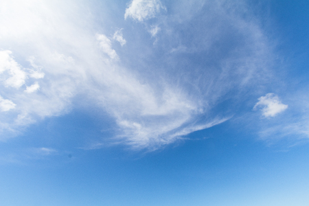 Clear blue sky background with white clouds.の写真素材