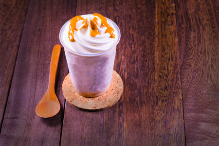Chocolate ice cream in a cup on a grey wooden table wall background with copy space .の写真素材